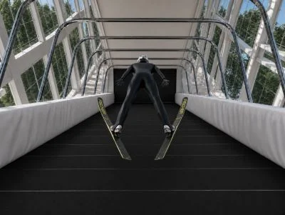 Ski jumper in the aerial flight position inside the Banana WS chamber, seen from behind with skis in the V-style