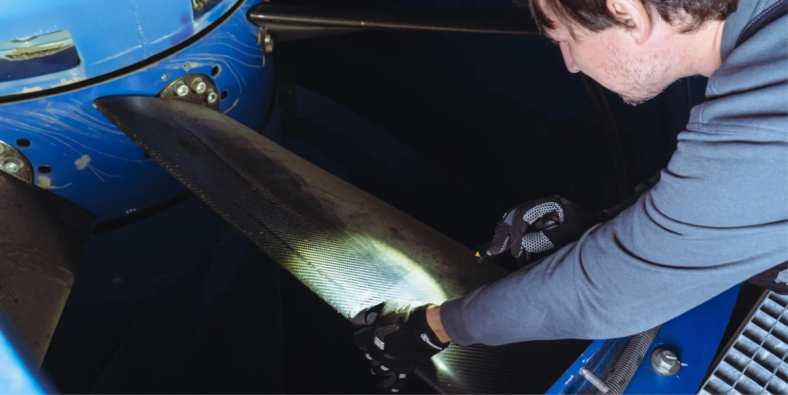 Engineer performing Wind Tunnel Maintenance Check on Turbine Blades